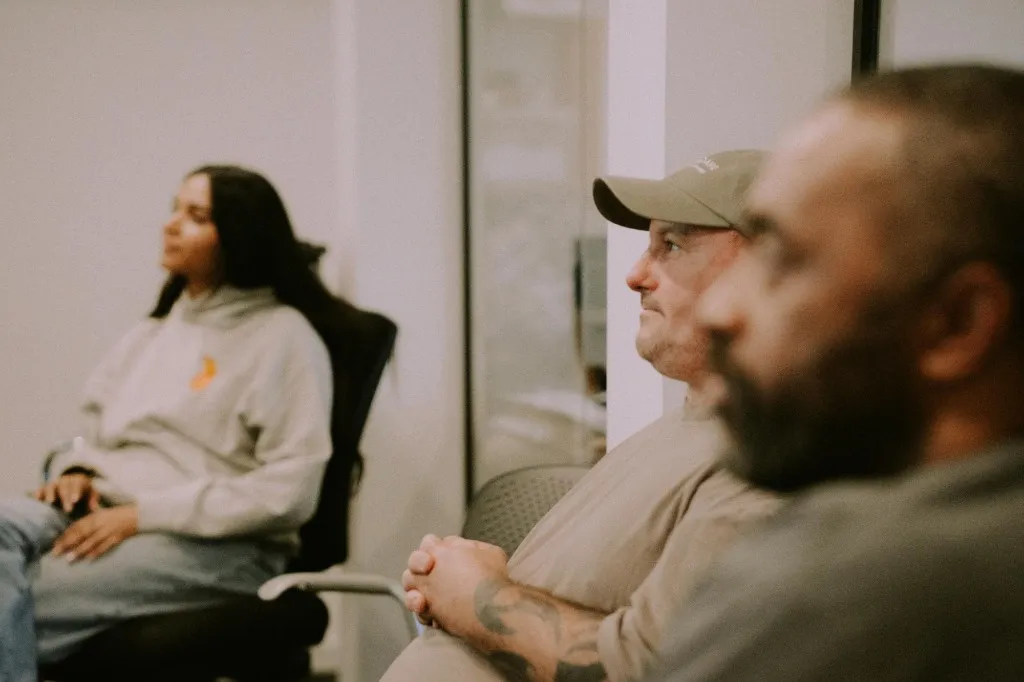 Star Compass team members listening together in a meeting.